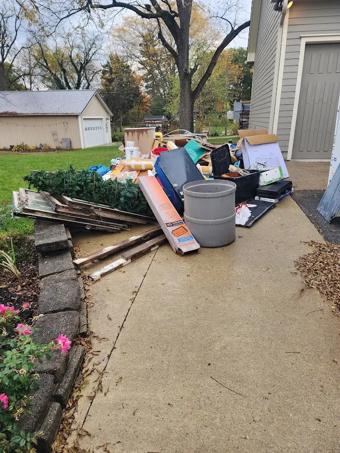 Dumpster being loaded with debris for Estate Cleanout Dumpster Rental in Wildwood